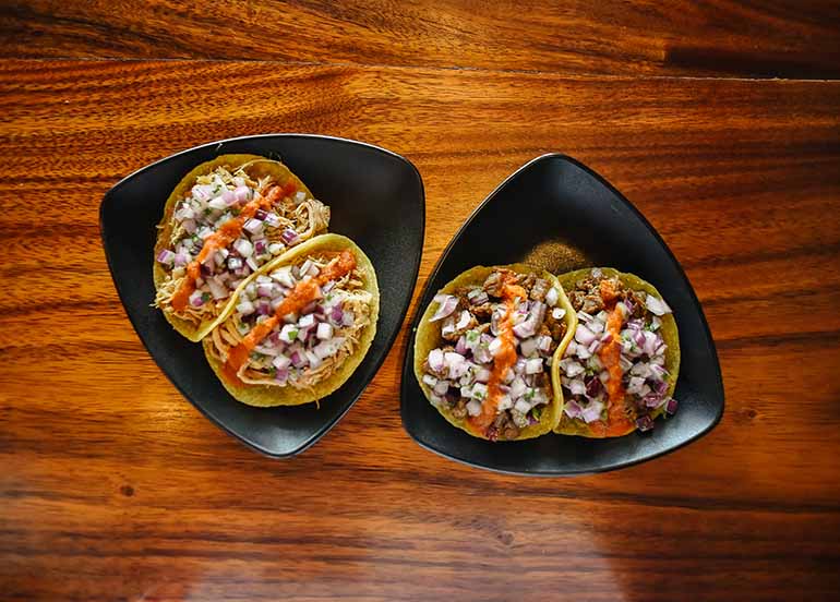 Carne Asada Taco and Braised Carnitas Taco from Vatos Urban Tacos.