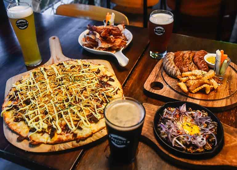Sisig, Sausage Platter, Beer, Cheesesteak Pizza from The Perfect Pint