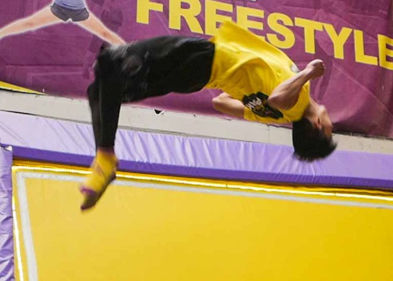 Guy tumbling Trampoline Park