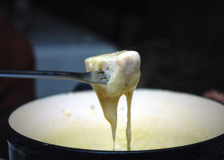 Melty cheese fondue with a piece of bread