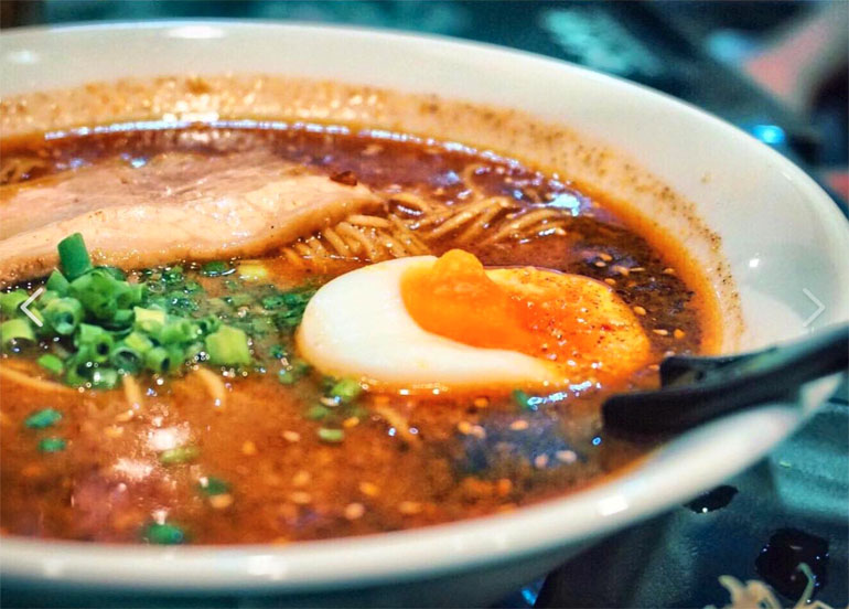 Ramen Kuroda Ramen topped with tamago, chasu, spring onions, and noodles