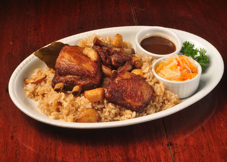 Cafe Adriatico Adobo Spareribs in a bed of rice with sauce and atchara
