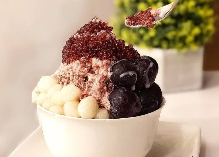 Purple In Love shaved ice dessert topped with Grapes, Mochi balls, and pomegranate