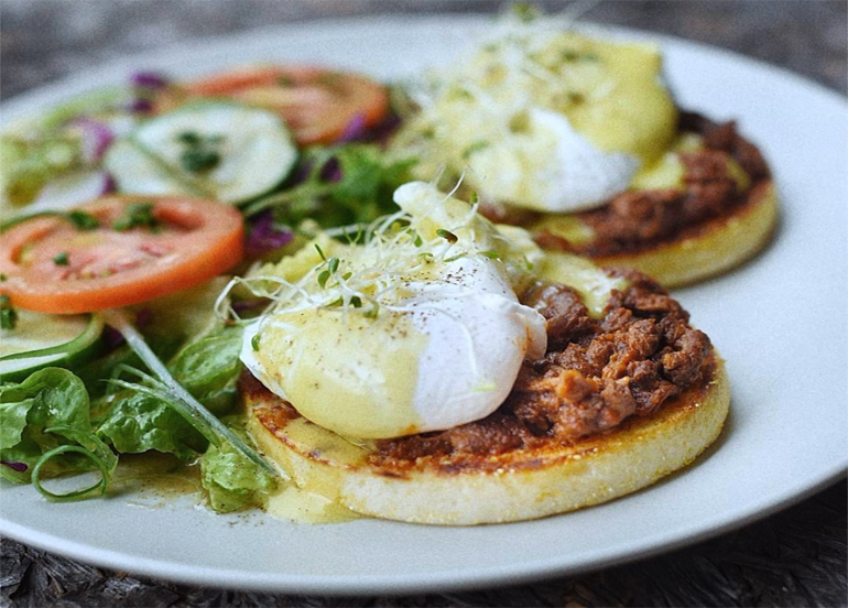 Eggs for Breakfast Eggs Benedict filled with simmered beef and lathered with hollandaise sauce, comes with a side salad
