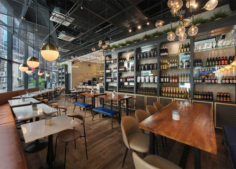 Refinery Interior with an assortment of alcoholic beverages lined up on the walls