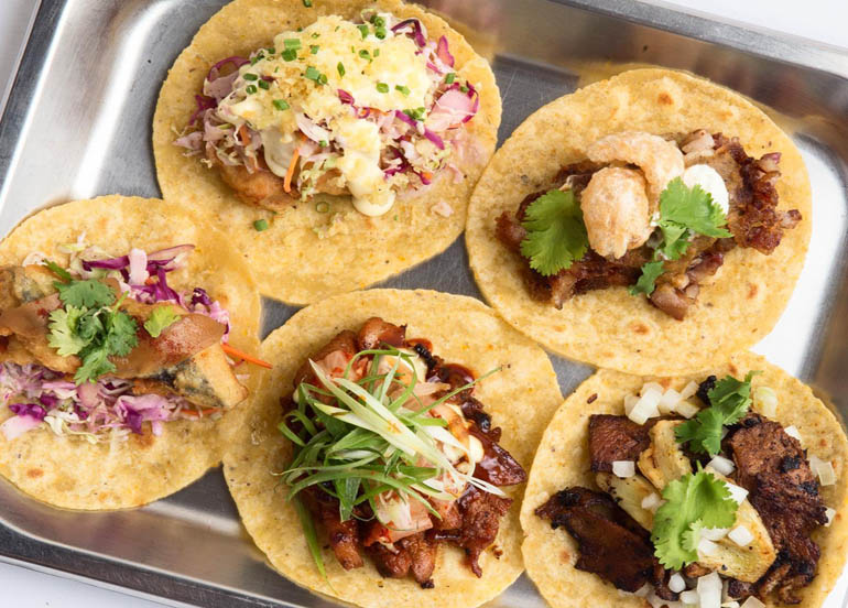 An assortment of soft-shell tacos from Vengo topped with unique ingredients