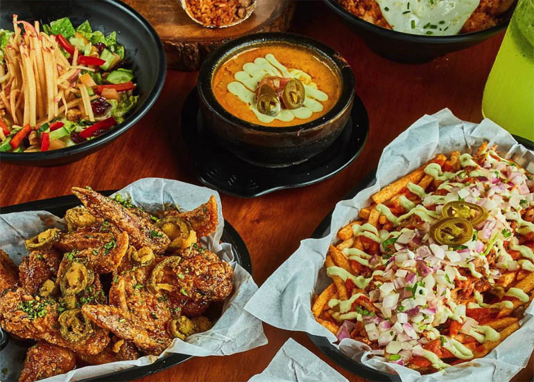 An assortment of dishes with Mexican influence from Vatos Urban Tacos