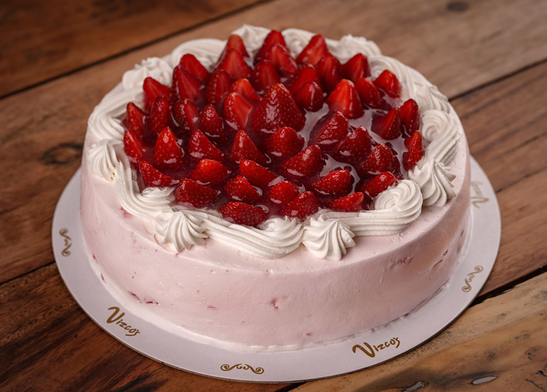 Vizco's Famous Strawberry Shortcake topped with fresh cream, strawberries, and a glaze