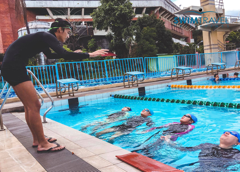 Students from Swimtravel PH floating in the pool