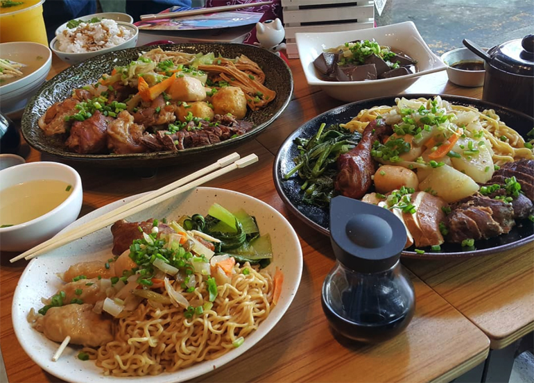 assortment of stews with meat and vegetables on a table from braises n' stews